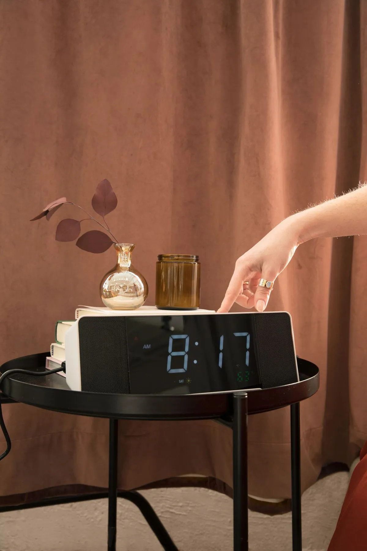 an alarm clock on a side table